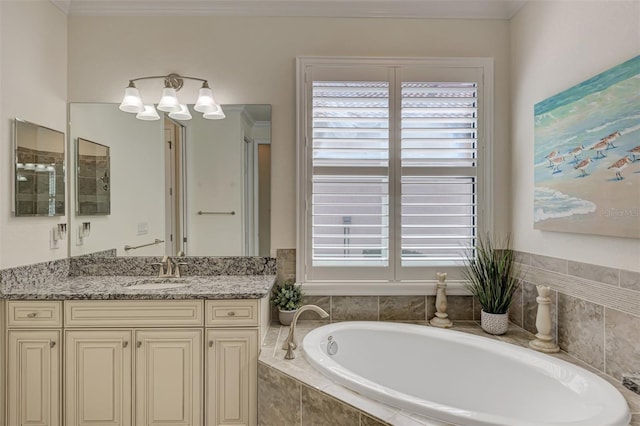 bathroom featuring a relaxing tiled bath, crown molding, and vanity