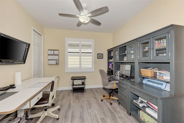 office space with light hardwood / wood-style floors and ceiling fan