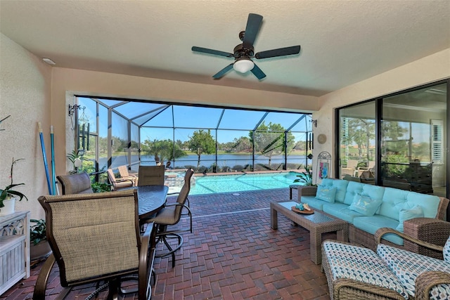 sunroom / solarium featuring ceiling fan and plenty of natural light