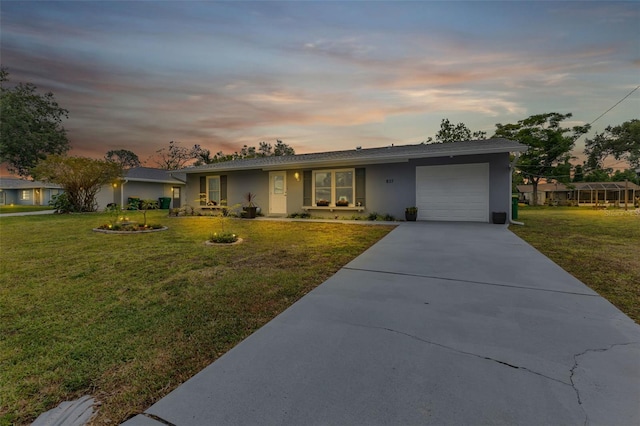 single story home with a yard and a garage