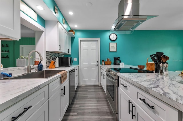 kitchen featuring dark wood-type flooring, white cabinetry, appliances with stainless steel finishes, island exhaust hood, and tasteful backsplash