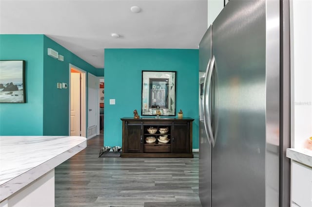 kitchen featuring wood-type flooring and stainless steel fridge