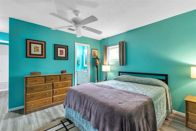 bedroom with hardwood / wood-style flooring, connected bathroom, ceiling fan, and a textured ceiling