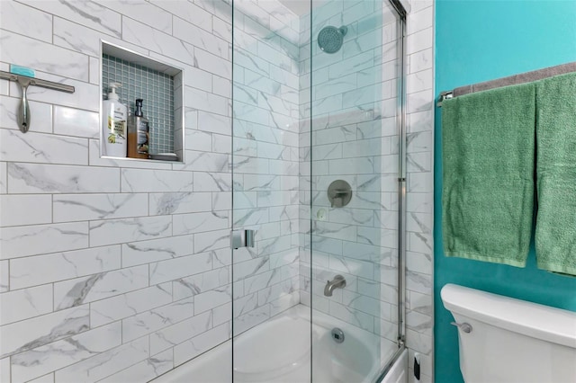 bathroom featuring enclosed tub / shower combo and toilet