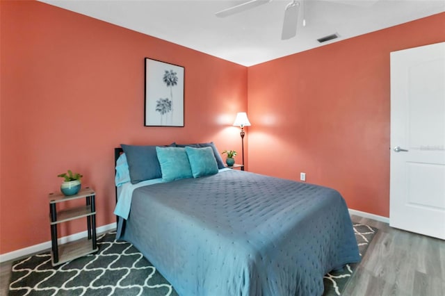 bedroom featuring dark hardwood / wood-style flooring and ceiling fan