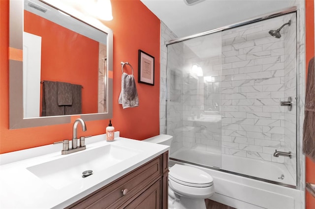 full bathroom with toilet, combined bath / shower with glass door, and vanity