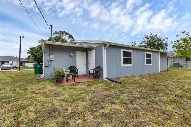 rear view of property with a patio and a yard