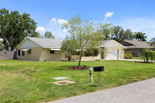 single story home with a front yard and a garage