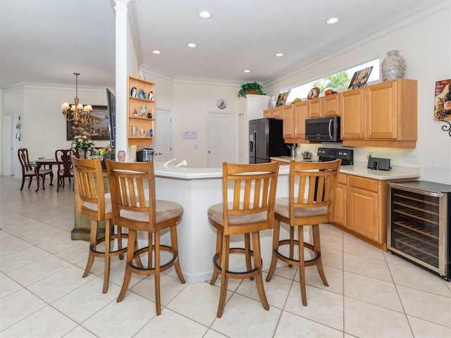 kitchen with ornamental molding, black fridge, light tile patterned floors, and beverage cooler