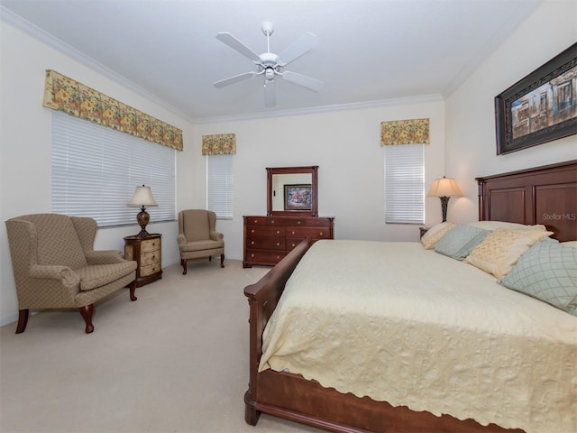 bedroom featuring ornamental molding, light colored carpet, and ceiling fan