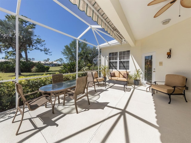 sunroom / solarium featuring ceiling fan