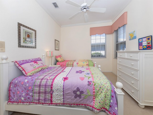 bedroom with crown molding, ceiling fan, and carpet floors