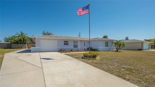 single story home featuring a front lawn and a garage