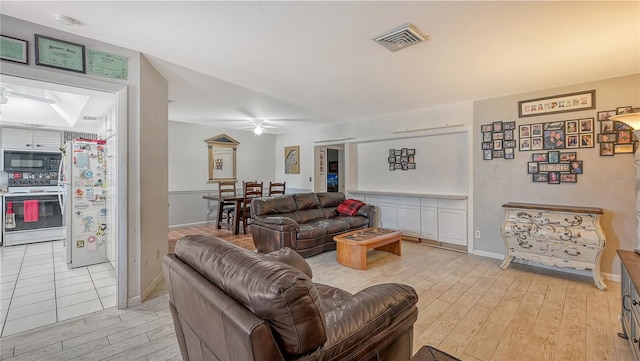 living room featuring ceiling fan and light wood-type flooring