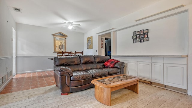 living room featuring ceiling fan and light hardwood / wood-style floors