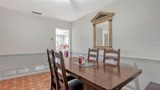 dining area featuring ceiling fan and tile floors