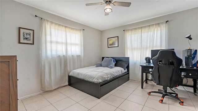 tiled bedroom with multiple windows and ceiling fan