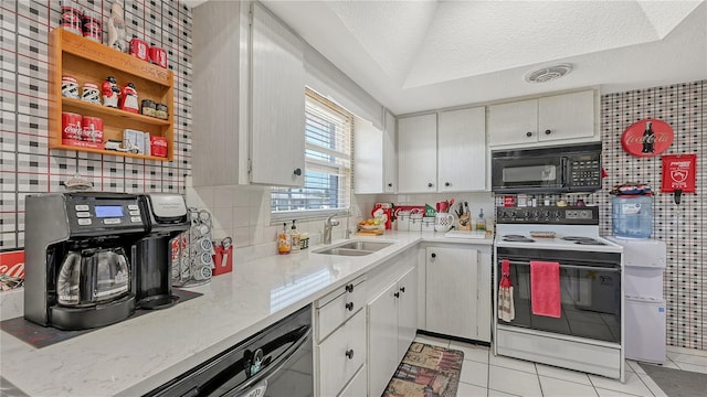 kitchen featuring sink, white electric range oven, light tile floors, and white cabinetry