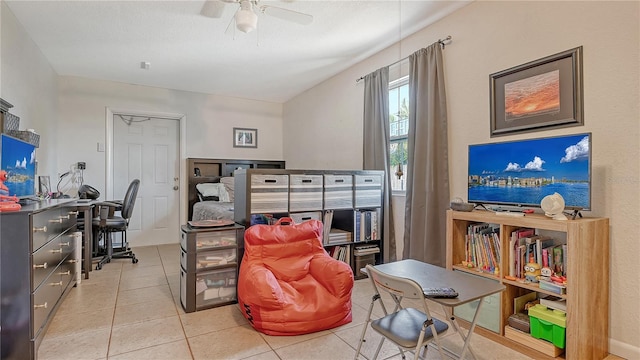 interior space with ceiling fan and light tile flooring