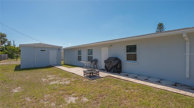 rear view of property featuring a yard and a patio