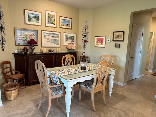 dining space featuring light tile floors