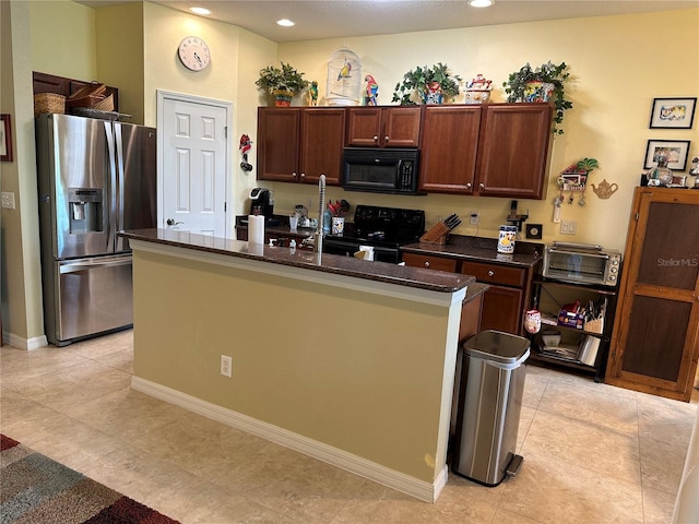 kitchen with electric range oven, stainless steel refrigerator with ice dispenser, light tile floors, dark stone countertops, and an island with sink