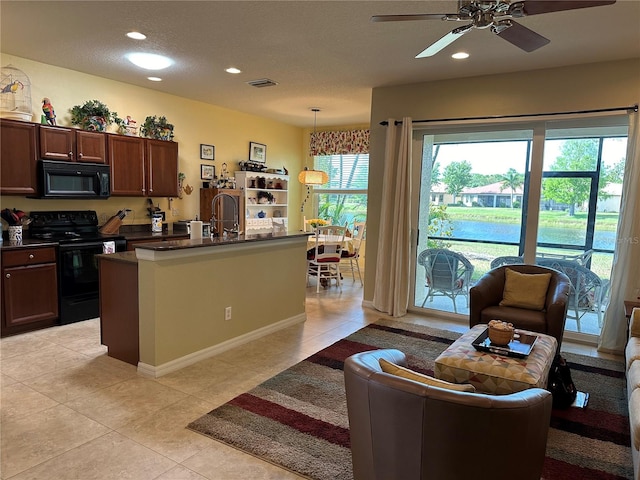 kitchen featuring ceiling fan, decorative light fixtures, light tile floors, and black appliances