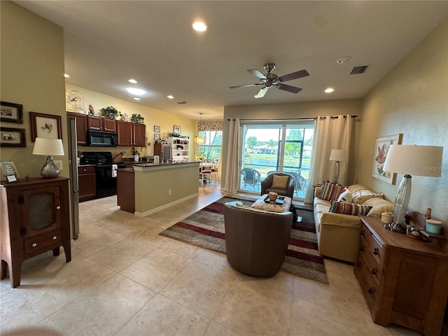 living room featuring ceiling fan and light tile floors