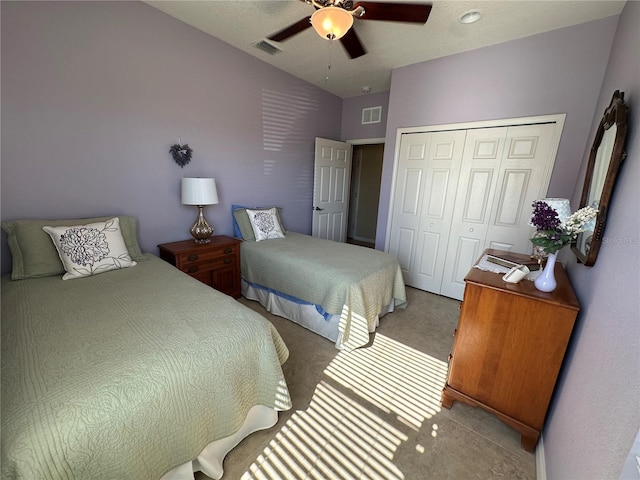 carpeted bedroom featuring a closet and ceiling fan