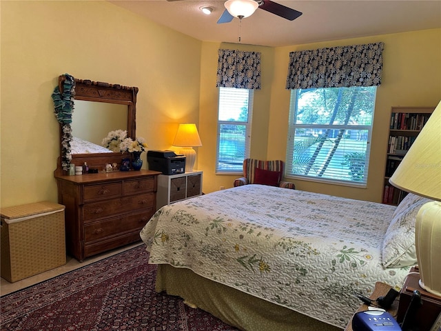 bedroom with ceiling fan and multiple windows