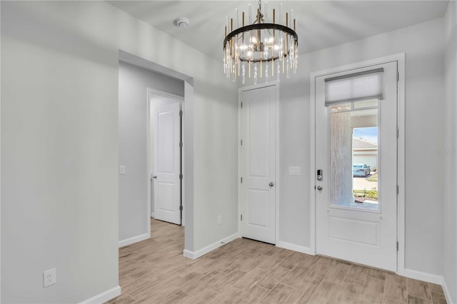 foyer entrance featuring a notable chandelier