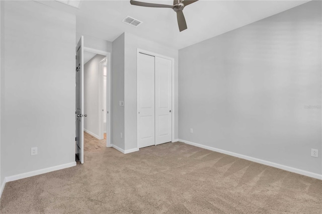 unfurnished bedroom with a closet, ceiling fan, and light colored carpet