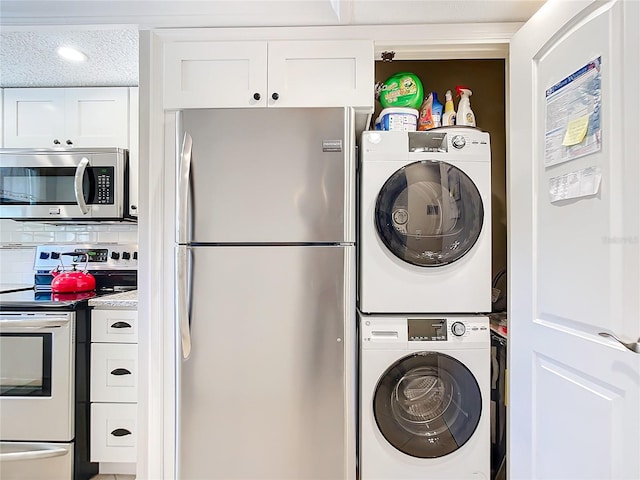 clothes washing area with stacked washer and clothes dryer