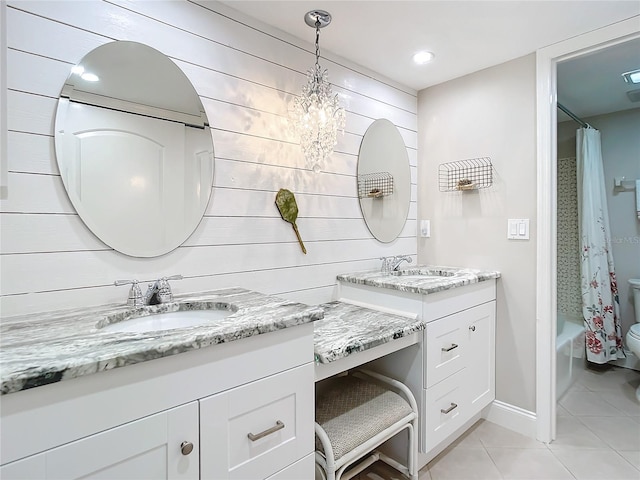 full bathroom featuring wood walls, shower / tub combo, tile floors, an inviting chandelier, and toilet