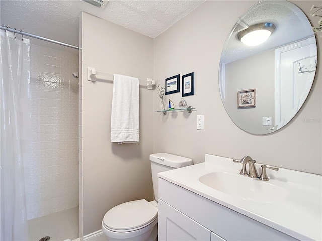 bathroom featuring walk in shower, vanity, toilet, and a textured ceiling