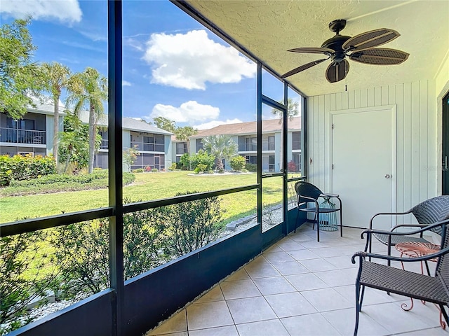 sunroom featuring ceiling fan