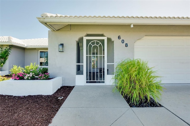 view of exterior entry featuring a garage