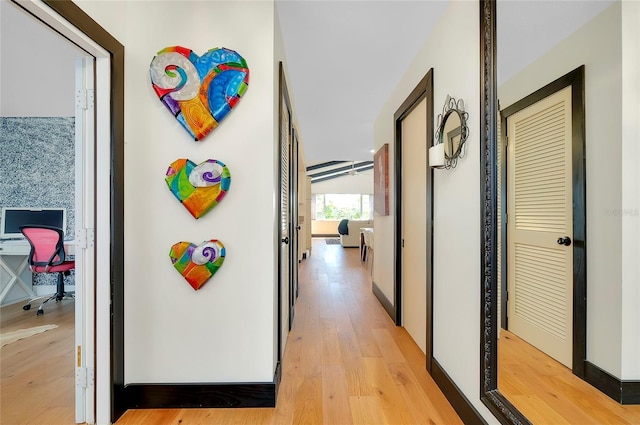 corridor with light hardwood / wood-style floors