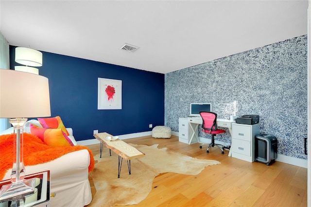 office area with light hardwood / wood-style floors