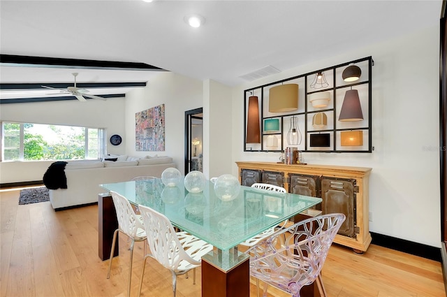 dining area with ceiling fan, light hardwood / wood-style floors, and lofted ceiling with beams