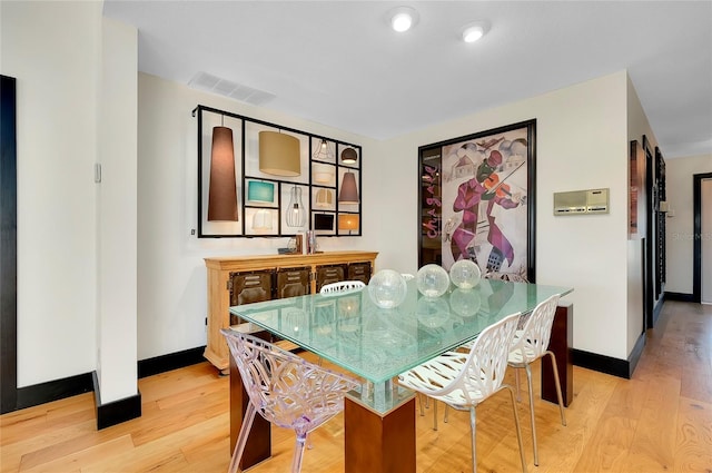 dining area with light hardwood / wood-style floors