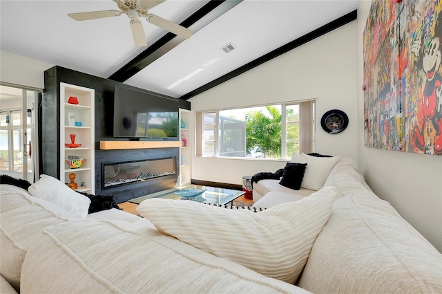 living room featuring hardwood / wood-style flooring, ceiling fan, vaulted ceiling with beams, and a fireplace