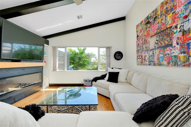 living room with hardwood / wood-style flooring and lofted ceiling with beams