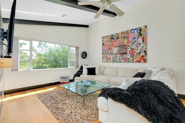 living room featuring hardwood / wood-style flooring, ceiling fan, and vaulted ceiling with beams