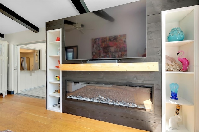 interior details featuring hardwood / wood-style flooring, stainless steel refrigerator, ceiling fan, built in shelves, and beamed ceiling