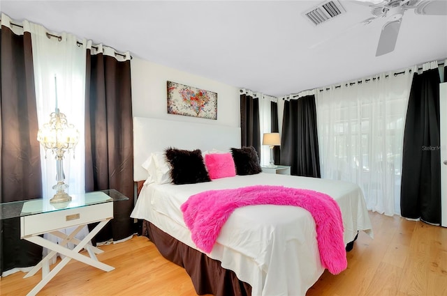 bedroom with hardwood / wood-style flooring and ceiling fan