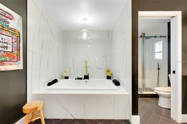 bathroom with tile patterned floors, toilet, and independent shower and bath