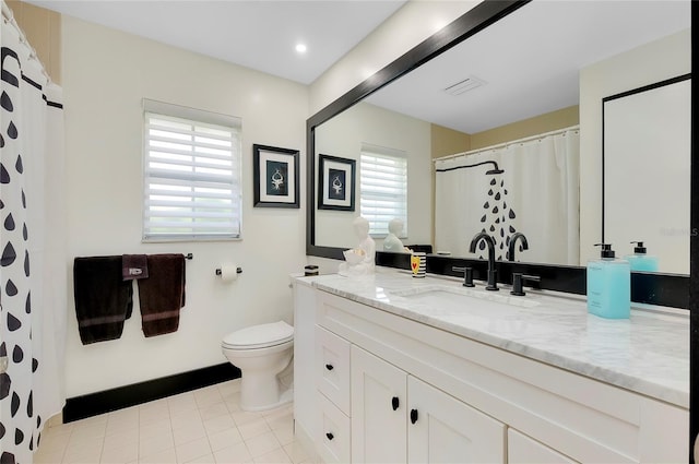 bathroom with vanity, tile patterned floors, and toilet