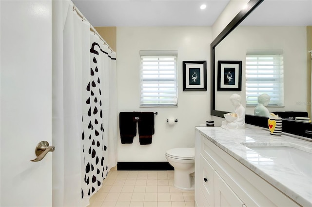 bathroom with walk in shower, vanity, toilet, and tile patterned flooring