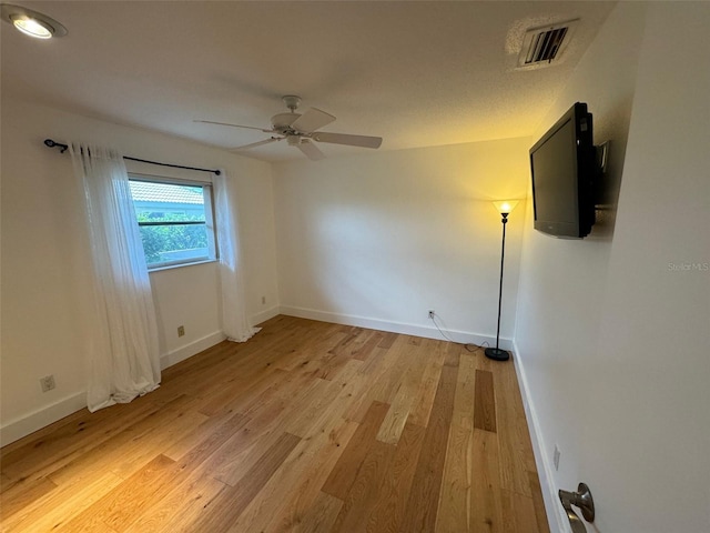 spare room featuring ceiling fan and light wood-type flooring